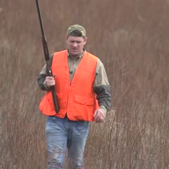 man catches flying bird with bare hand