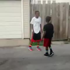 Kid Punches Boy While Ghost Riding Bike