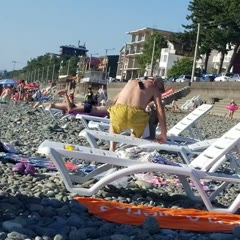 Guy at Beach Searches for Phone While it's Stuck to His Back