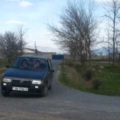 Teenagers in Albania try to drift a car on a narrow road