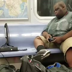 Man plays Xbox 360 on NYC subway