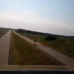 Car Drives Over Buckled Pavement