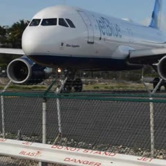 Girl blown by a plane on the beach at Maho Sint Maarten