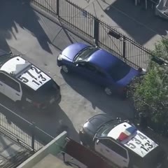 'Come on guys! He's right there!': Pursuit suspect tries to evade LAPD by laying next to vehicle