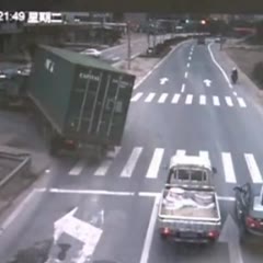 Motorcycle narrowly misses container truck hit