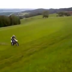 Motorcycle jumps uphill over street