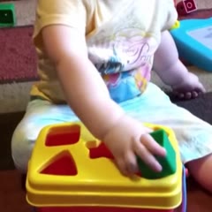 Toddler gives up trying to figure out which hole the shape fits in