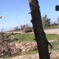 FSA rebel throws explosive down Syrian army tank barrel