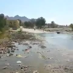 Scooter rider has some fun with water covered road