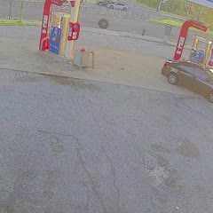 Trash Truck Tire Meets Car Caboose in Gas Station Conundrum