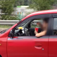 Korean Woman Eats with Chopsticks While Driving